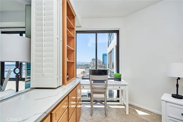 a view of workspace with furniture and window