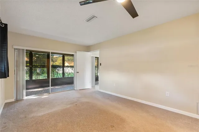 a view of an empty room with windows