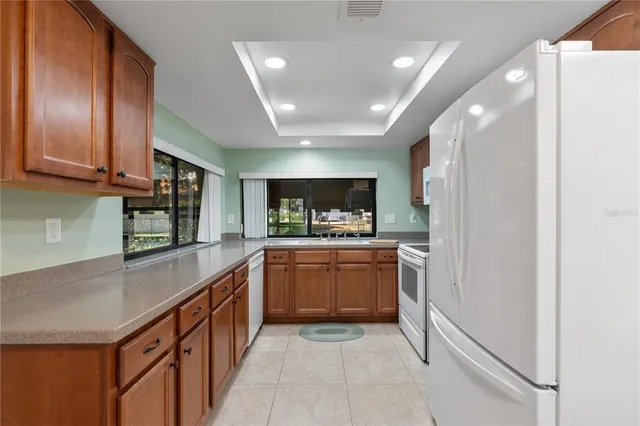 a kitchen with stainless steel appliances granite countertop a sink and stove top oven