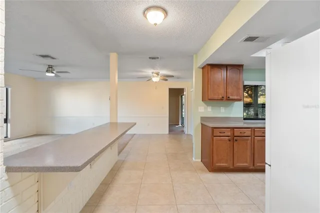 a spacious bathroom with a granite countertop sink a mirror and a bathtub