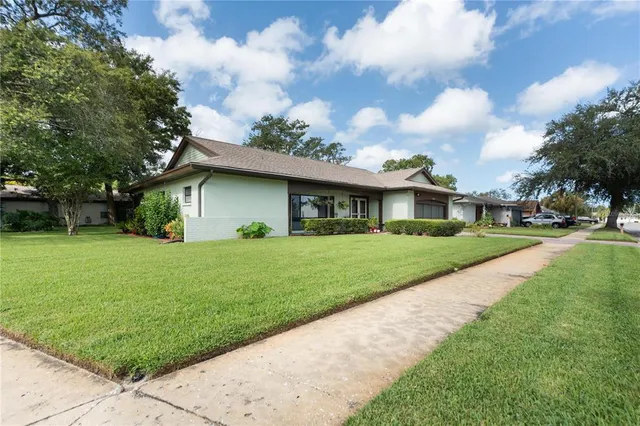 a front view of house with yard and green space