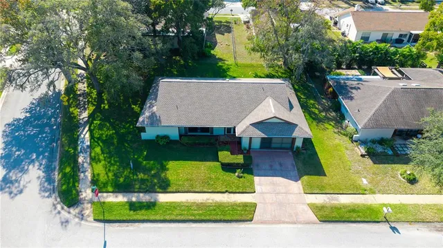 an aerial view of a house with yard swimming pool and outdoor seating