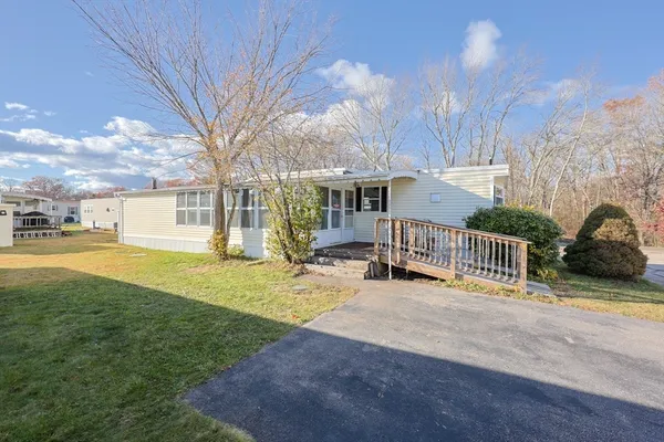 a view of a house with backyard and sitting area