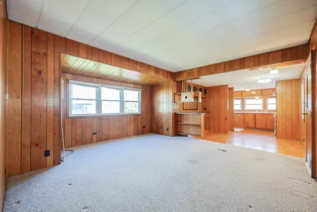 an empty room with furniture and a window