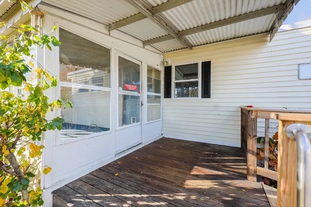 a view of a porch with a table and chairs and potted plants