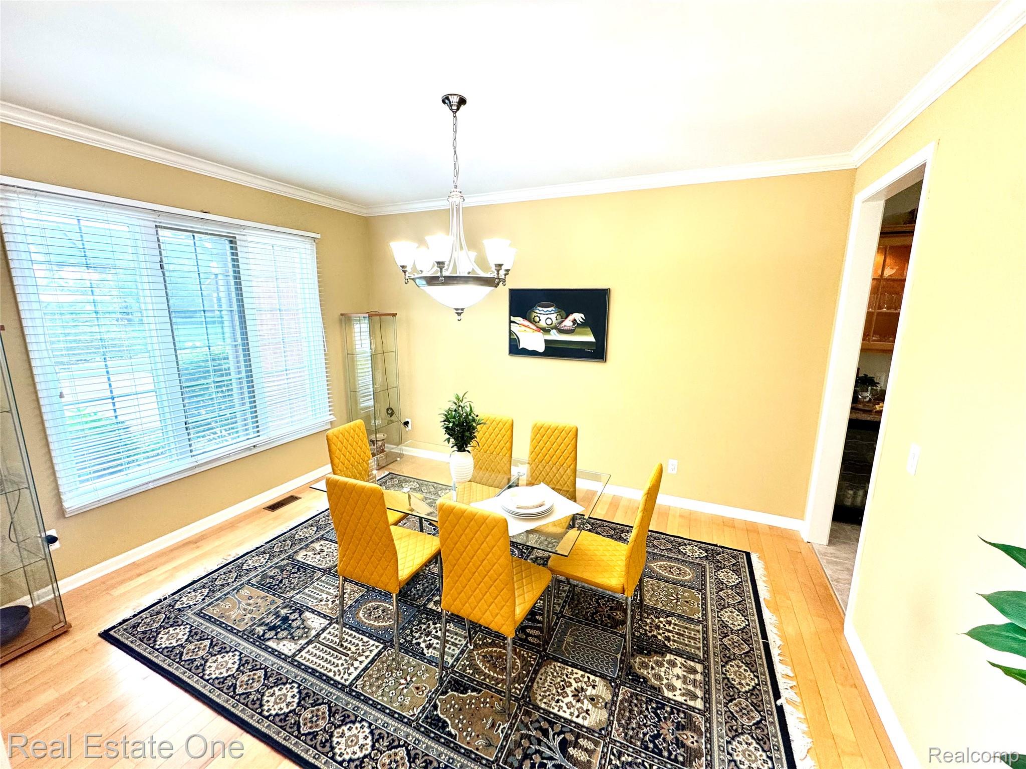 1215 Letica Drive Rochester, MI 48307 - Photo 13 of 43 Dining space with light wood-type flooring, ornamental molding, and suspended lighting