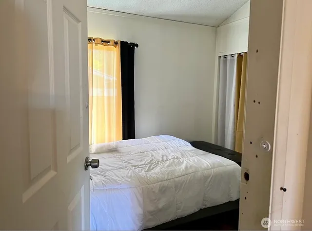 a bedroom with a bed and a window