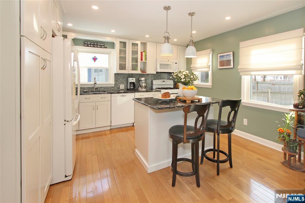 14 Davidson Road Bloomfield, NJ 07003 - Photo 12 of 50 a kitchen with stainless steel appliances granite countertop a stove a sink a refrigerator and a dining table