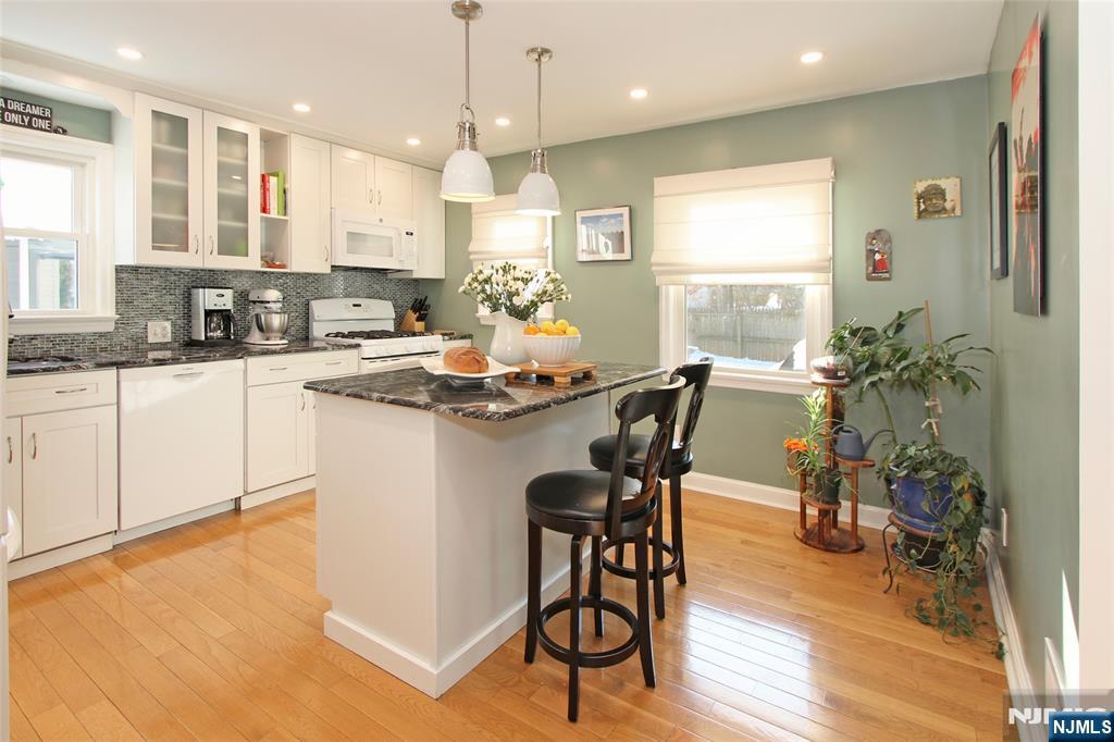 14 Davidson Road Bloomfield, NJ 07003 - Photo 17 of 50 a kitchen with kitchen island a stove a table and chairs in it