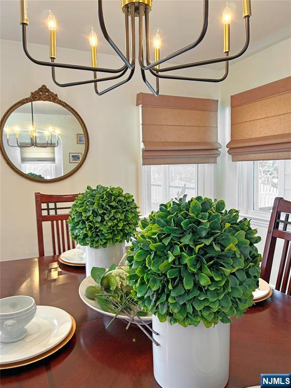 14 Davidson Road Bloomfield, NJ 07003 - Photo 20 of 50 a vase of flowers sitting on a table and chair with wooden floor