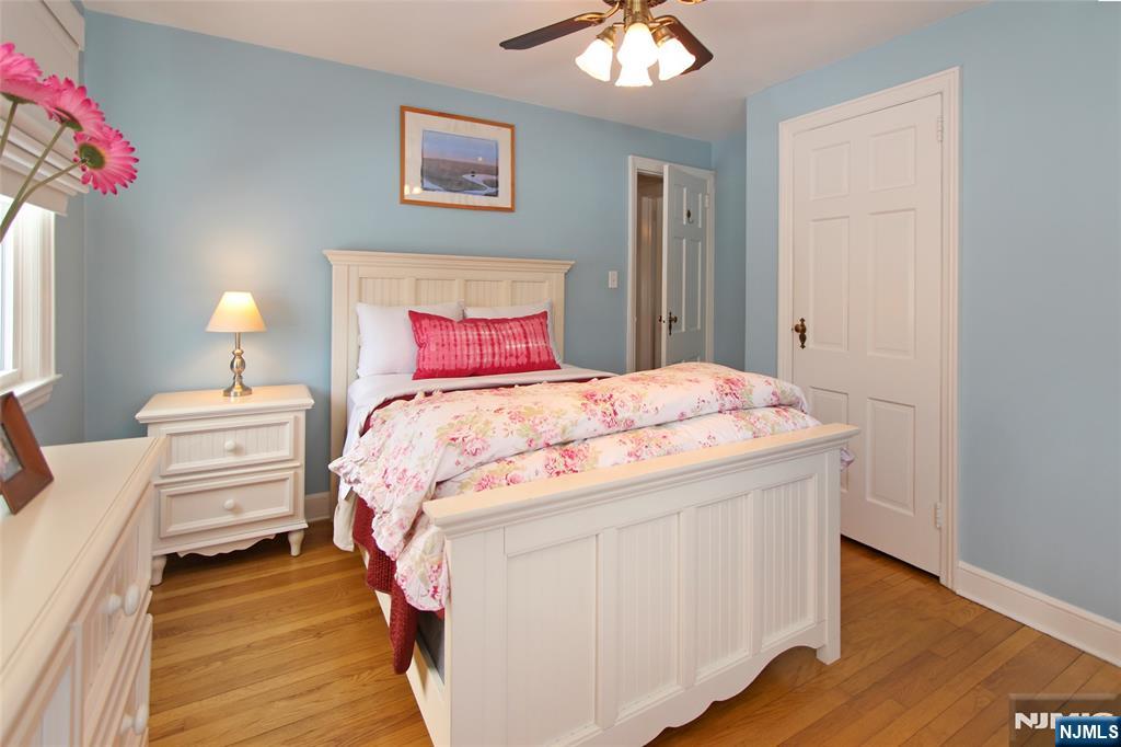 14 Davidson Road Bloomfield, NJ 07003 - Photo 32 of 50 a bedroom with a bed and a chandelier