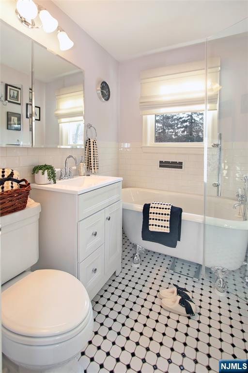 14 Davidson Road Bloomfield, NJ 07003 - Photo 38 of 50 a bathroom with a sink a toilet and a window