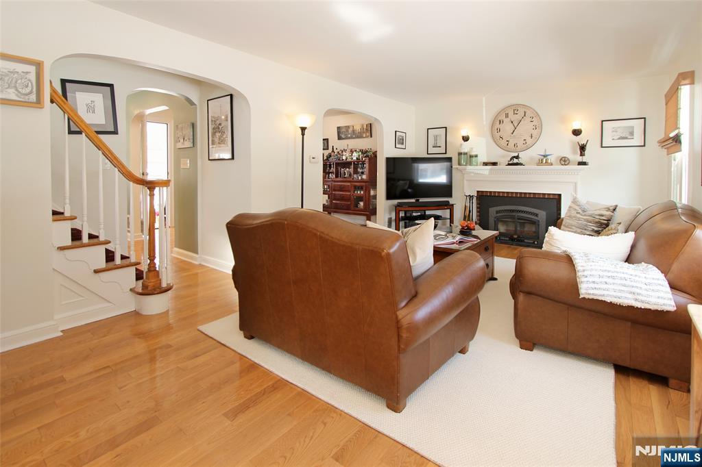 14 Davidson Road Bloomfield, NJ 07003 - Photo 6 of 50 a living room with furniture a clock and a fireplace