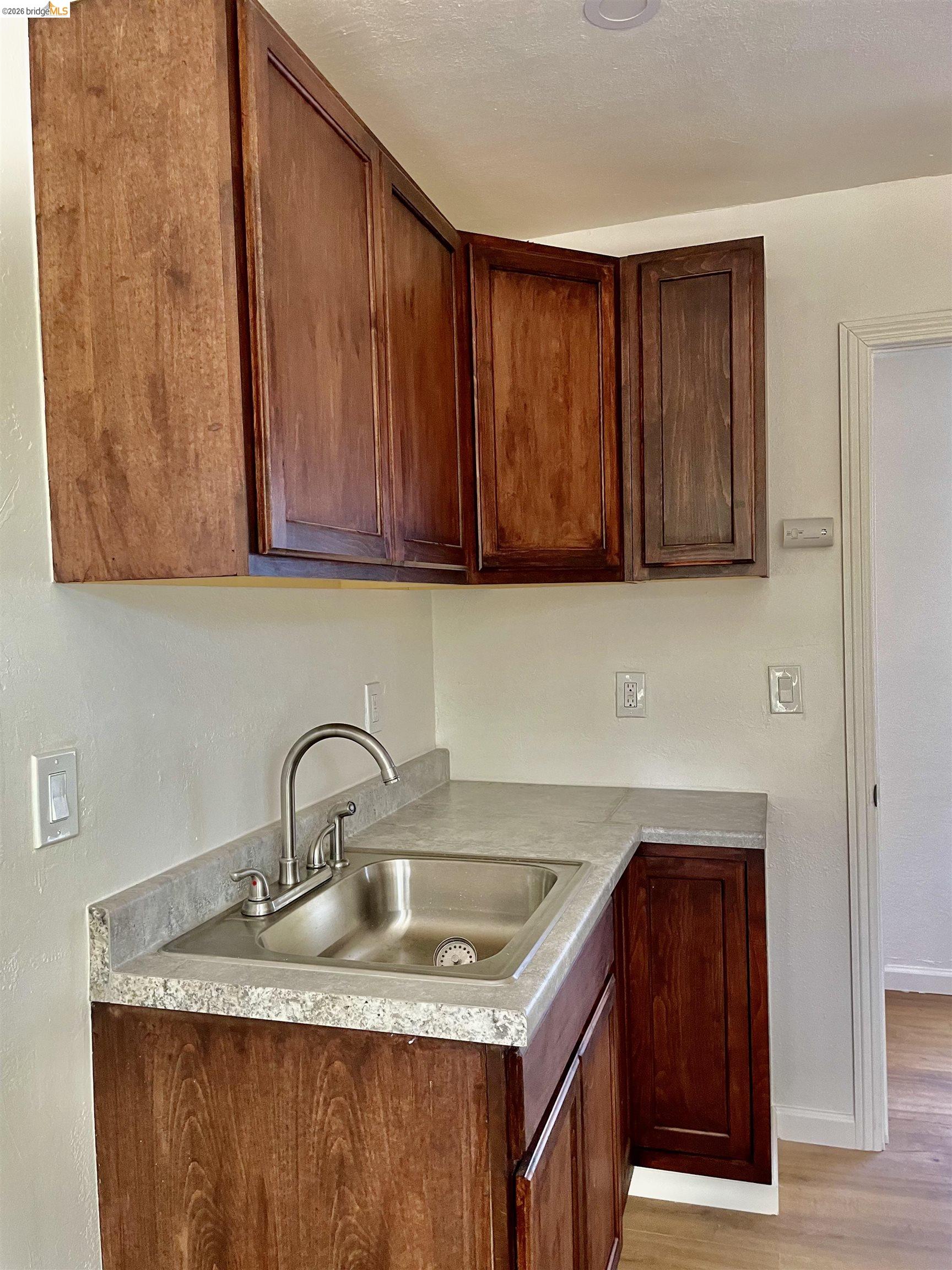 1507 Prince Street Berkeley, CA 94703 - Photo 16 of 30 a kitchen with granite countertop wood cabinets a sink and dishwasher