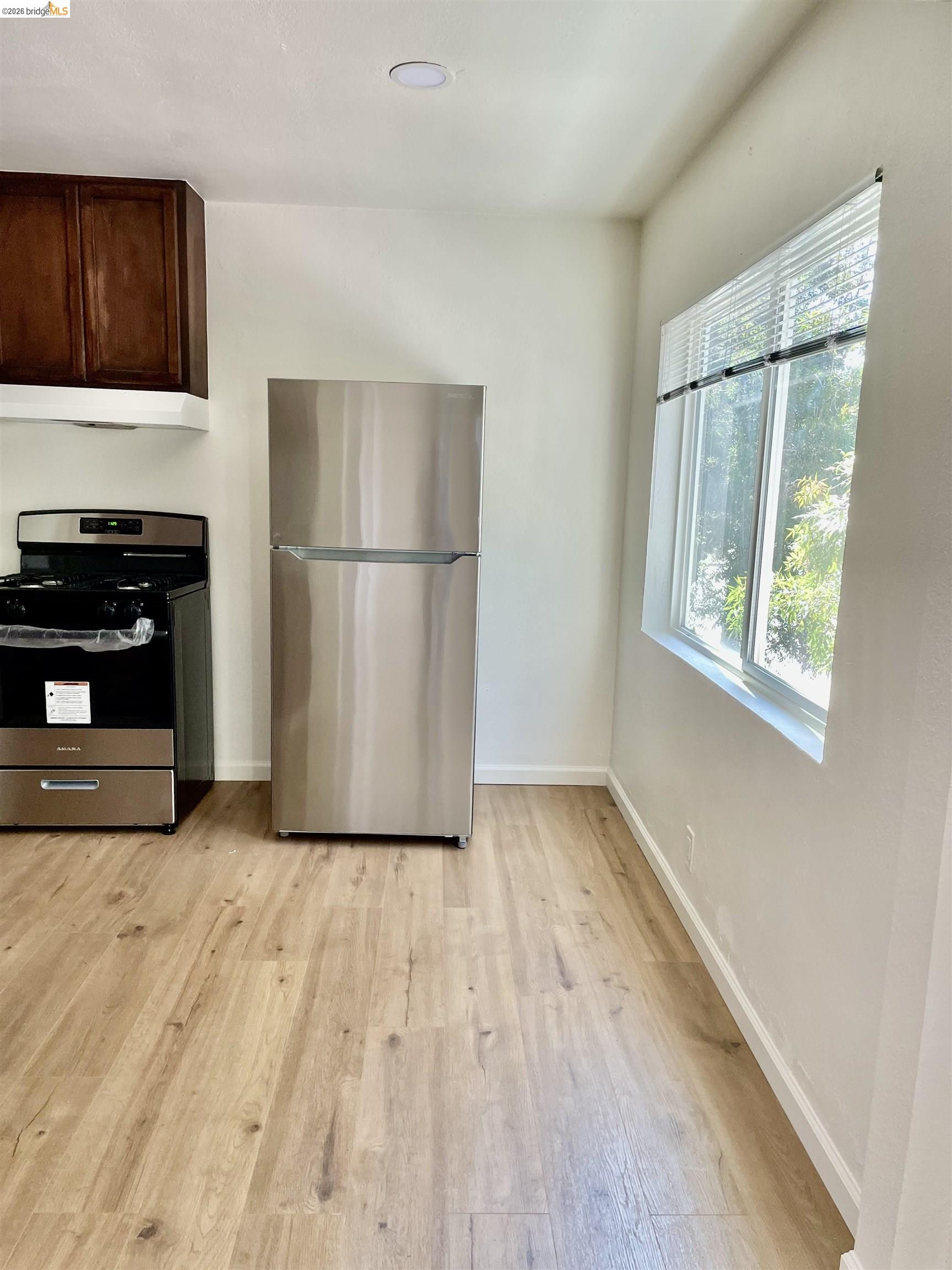 1507 Prince Street Berkeley, CA 94703 - Photo 22 of 30 a view of kitchen with wooden floor electronic appliances and window