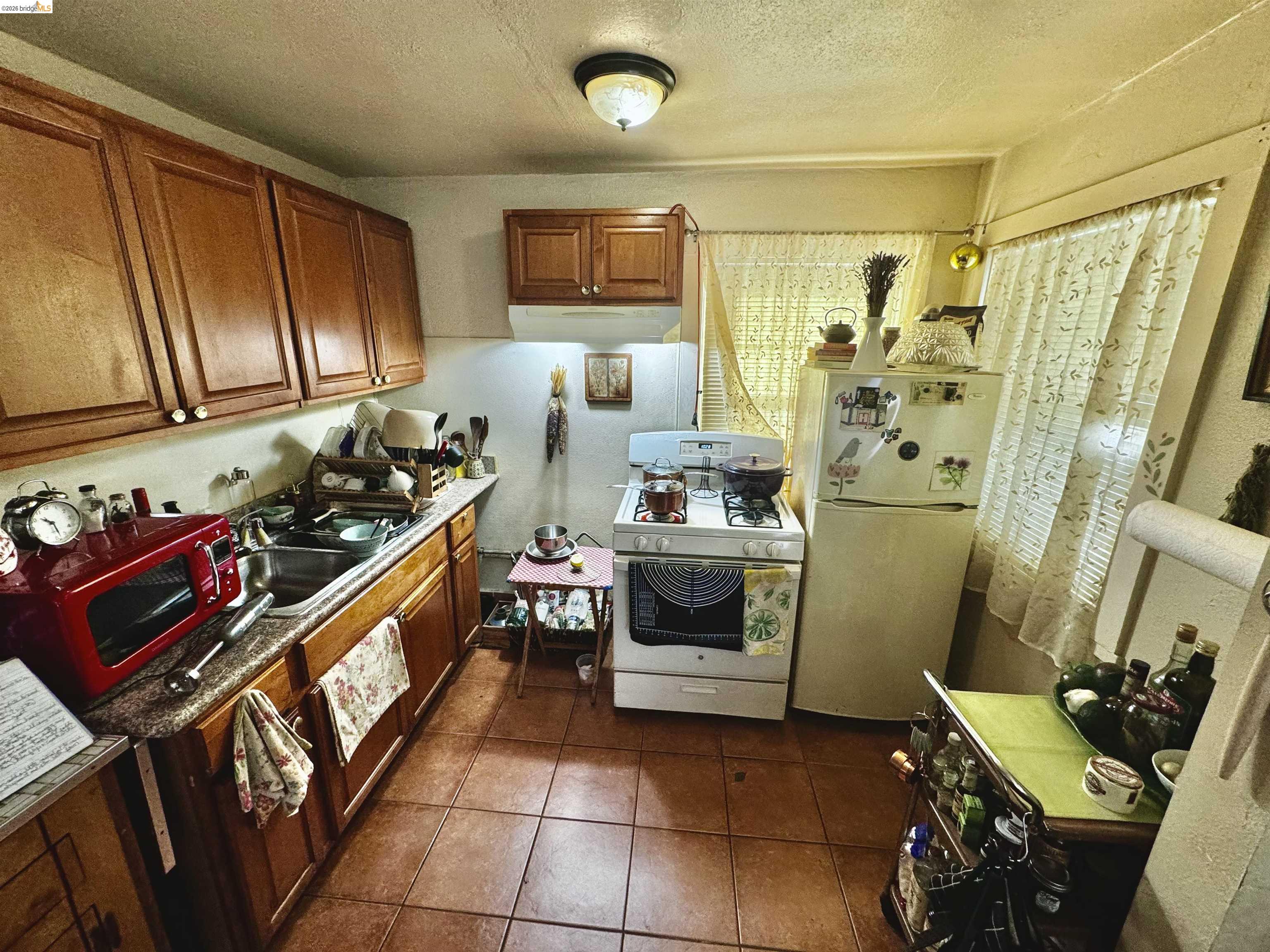 1507 Prince Street Berkeley, CA 94703 - Photo 25 of 30 a kitchen with stainless steel appliances a stove a refrigerator and cabinets