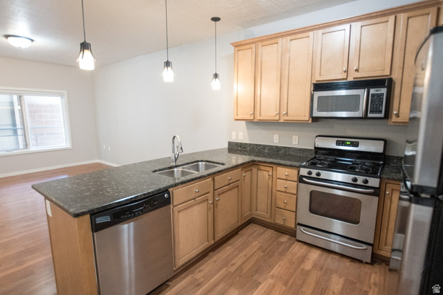 2150 South Main Street, Unit R405 Salt Lake City, UT 84115 - Photo 9 of 20 Kitchen featuring light wood cabinetry, stainless steel appliances, dark stone countertops, and wood-finish flooring