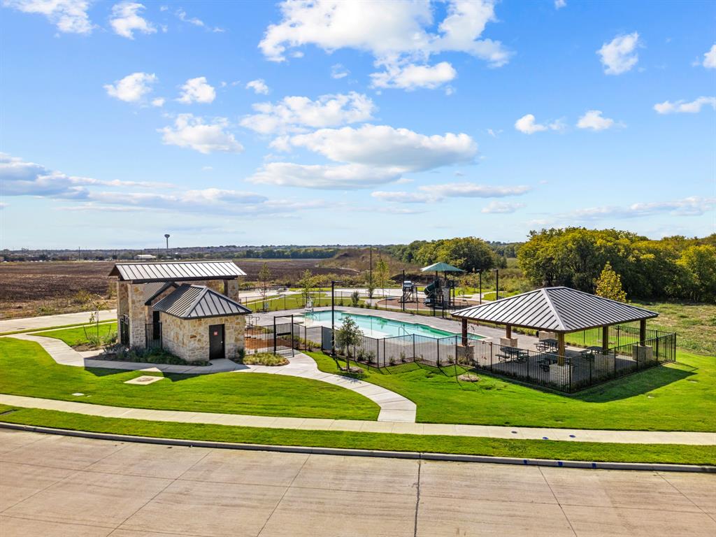 148 Hudson Lane Justin, TX 76247 - Photo 11 of 21 a view of a swimming pool with lawn chairs and a big yard