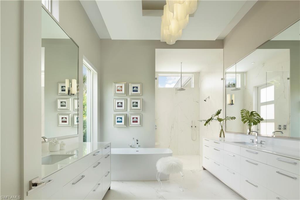 387 Bow Line Drive Naples, FL 34103 - Photo 13 of 18 a spacious bathroom with a bathtub shower sink and toilet