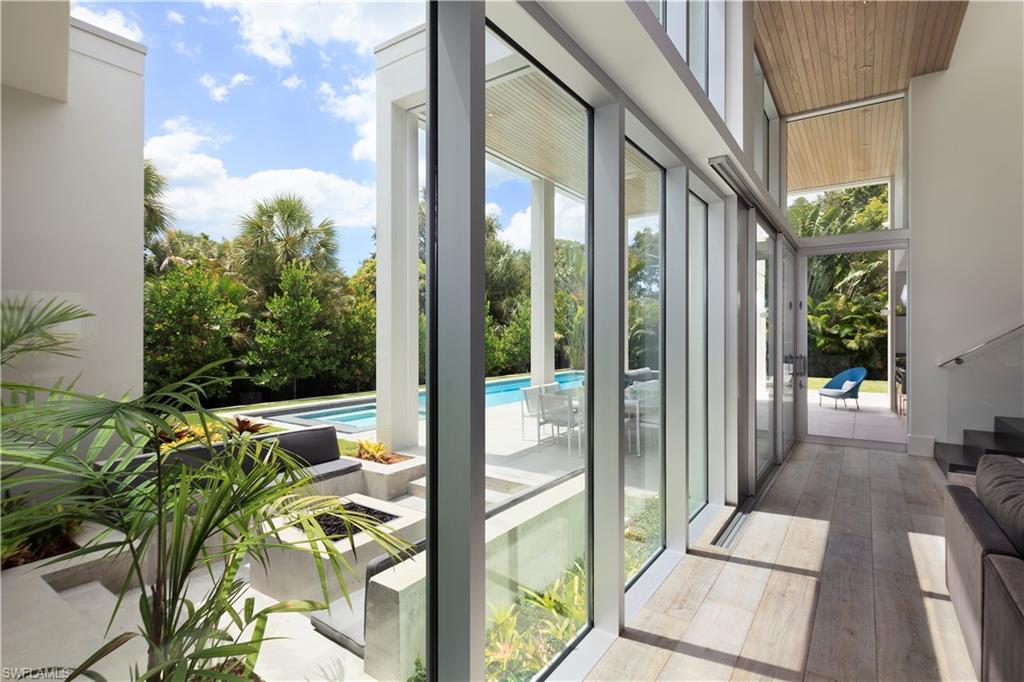 387 Bow Line Drive Naples, FL 34103 - Photo 14 of 18 a view of a balcony with potted plants