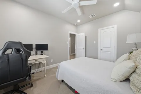 a bedroom with a bed and a television