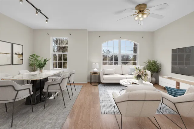 a living room with furniture a chandelier and a window