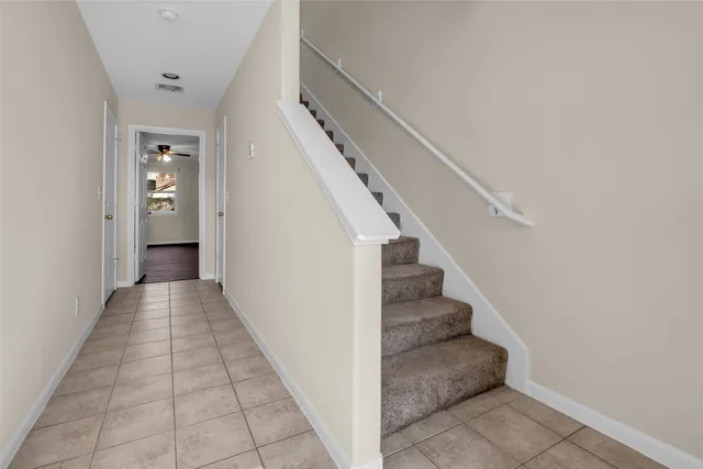 a view of a hallway with stairs