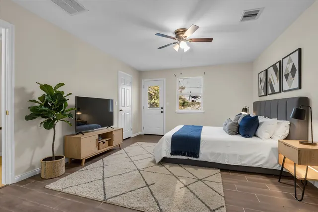 a bedroom with a bed and a flat screen tv