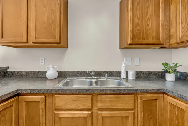 a kitchen with granite countertop stainless steel appliances sink and cabinets
