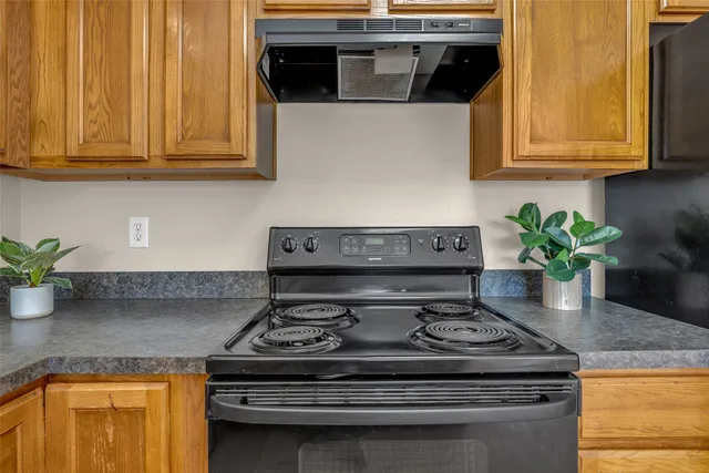 a stove top oven sitting inside of a kitchen