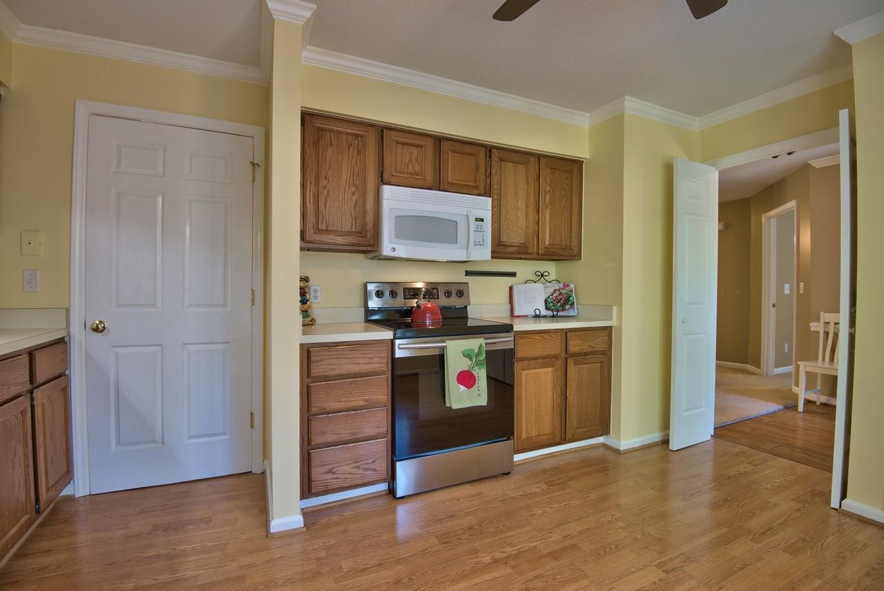 3219 Coachman's Way Durham, NC 27705 - Photo 12 of 33 a kitchen with stainless steel appliances granite countertop a refrigerator and a stove top oven