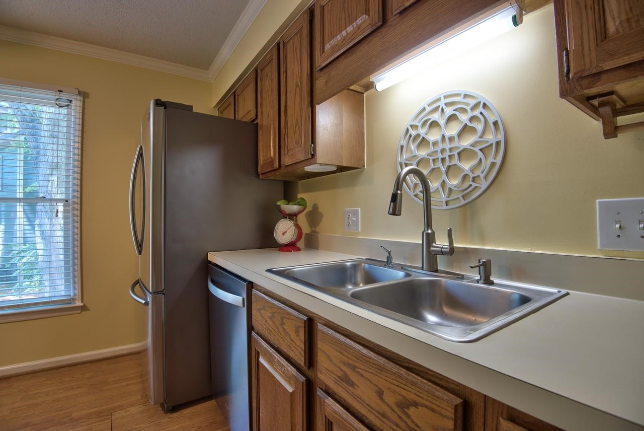 3219 Coachman's Way Durham, NC 27705 - Photo 13 of 33 a kitchen with a sink and a refrigerator