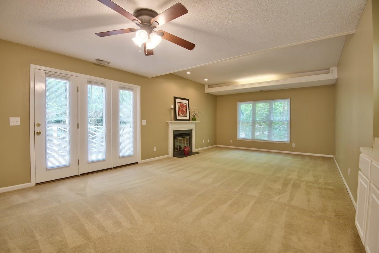 3219 Coachman's Way Durham, NC 27705 - Photo 16 of 33 a view of an empty room with a window and a kitchen