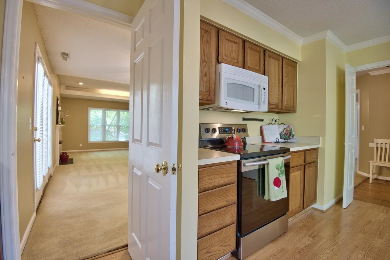 3219 Coachman's Way Durham, NC 27705 - Photo 20 of 33 a view of a kitchen cabinets and wooden floor