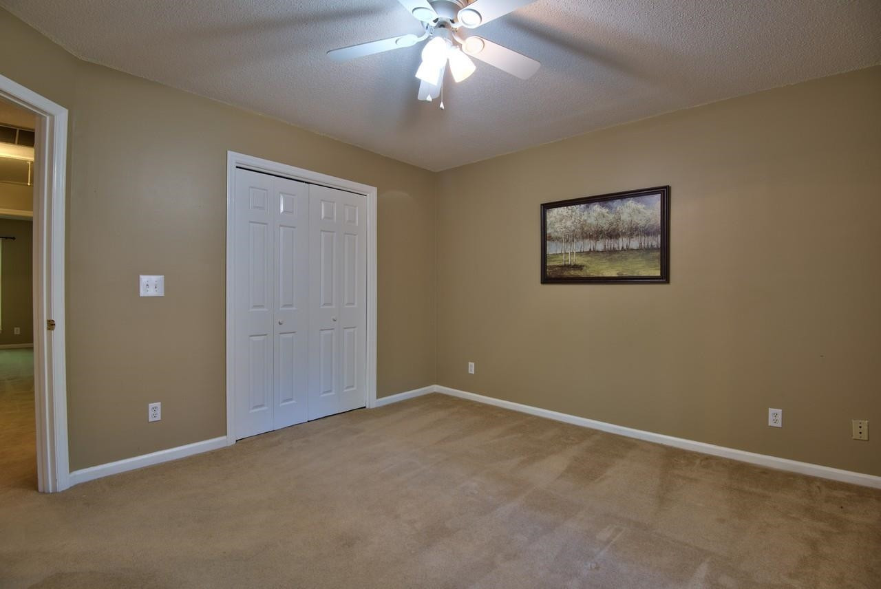 3219 Coachman's Way Durham, NC 27705 - Photo 23 of 33 an empty room with windows and fan