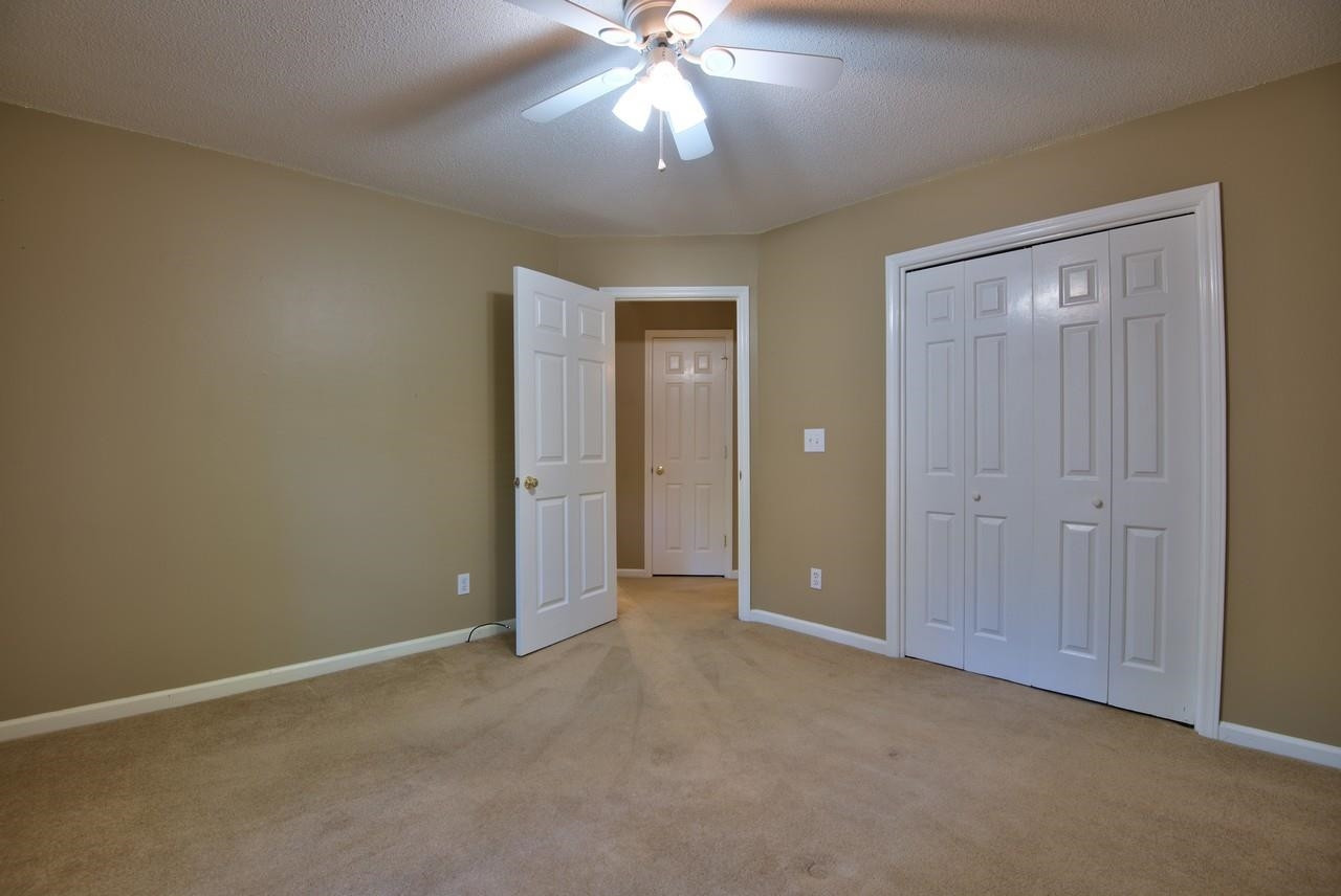 3219 Coachman's Way Durham, NC 27705 - Photo 24 of 33 an empty room with fan and entrance