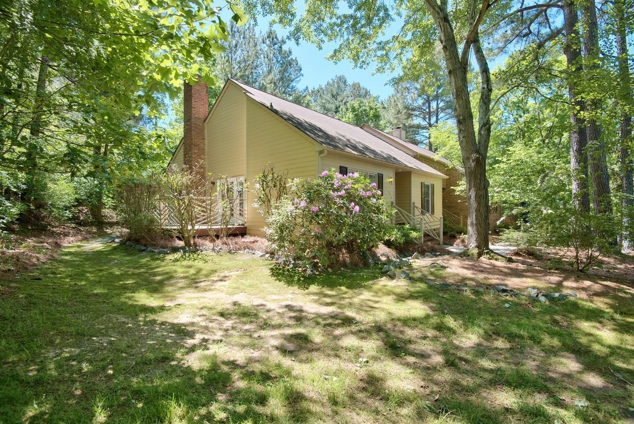 3219 Coachman's Way Durham, NC 27705 - Photo 4 of 33 a view of a house with a yard and plants