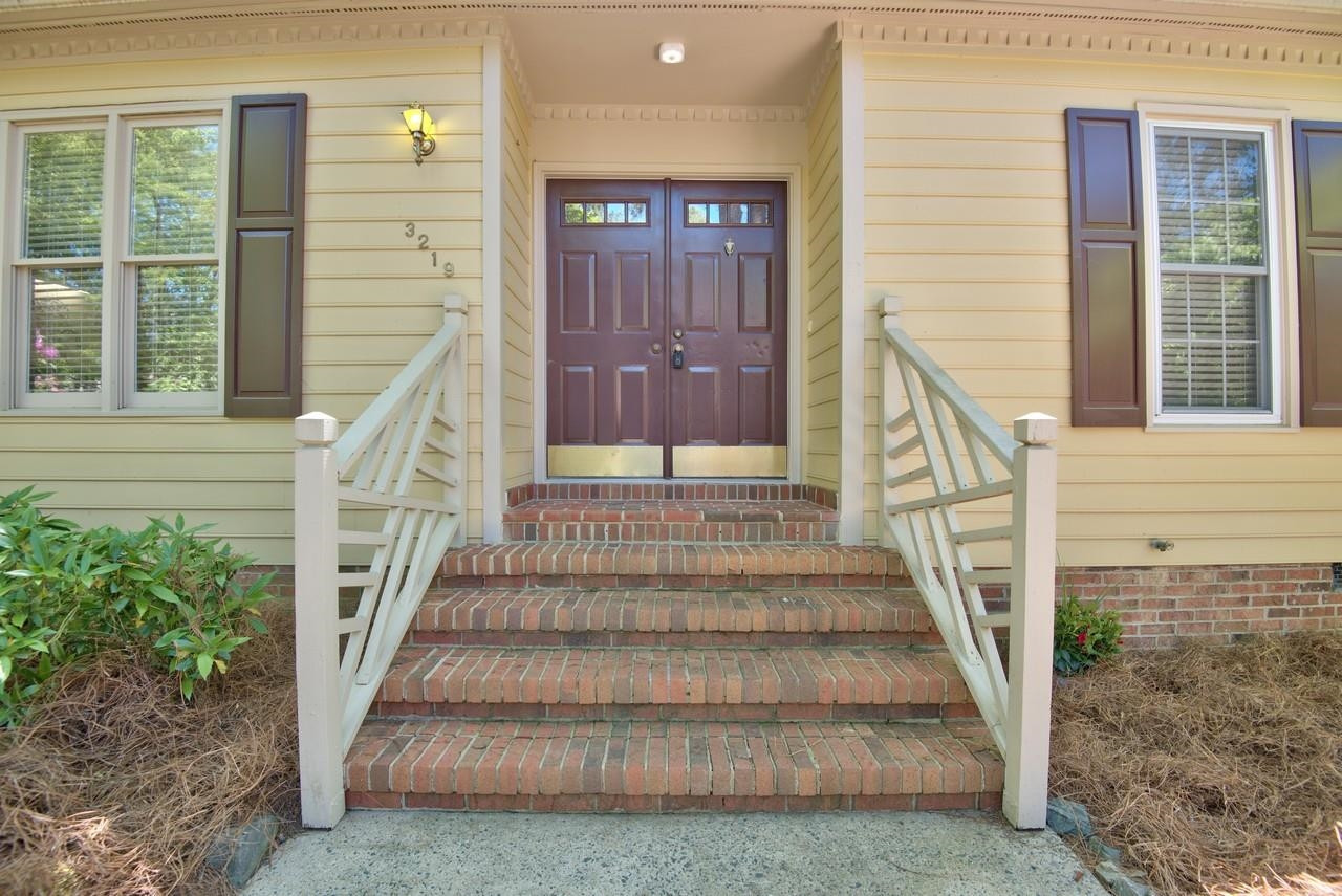 3219 Coachman's Way Durham, NC 27705 - Photo 8 of 33 a view of entryway with wooden floor and a front door