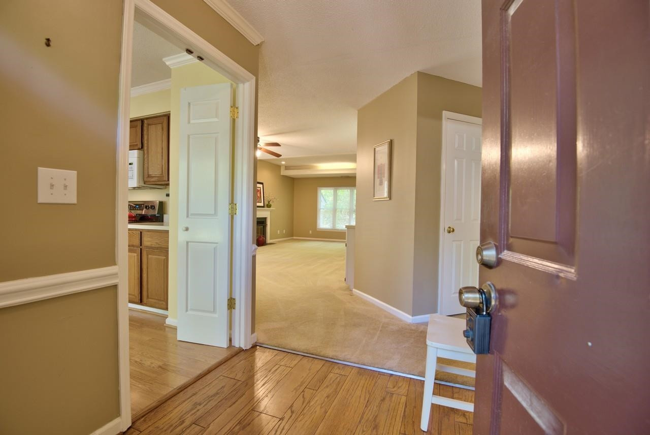 3219 Coachman's Way Durham, NC 27705 - Photo 9 of 33 a view of a hallway with wooden floor and cabinet