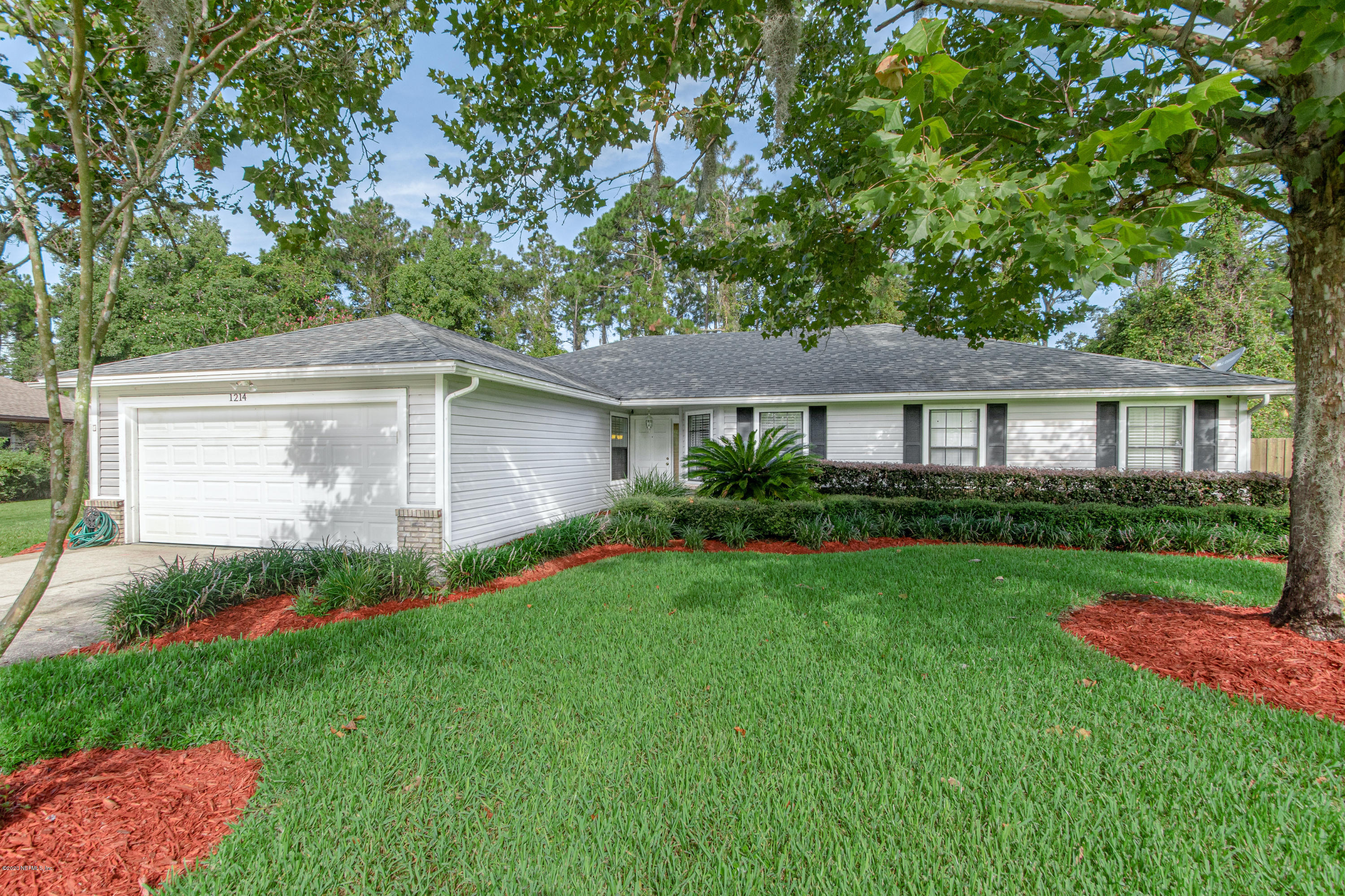 1214 Raleigh Ridge Drive Jacksonville, FL 32225 - Photo 1 of 25 a front view of a house with a garden and yard