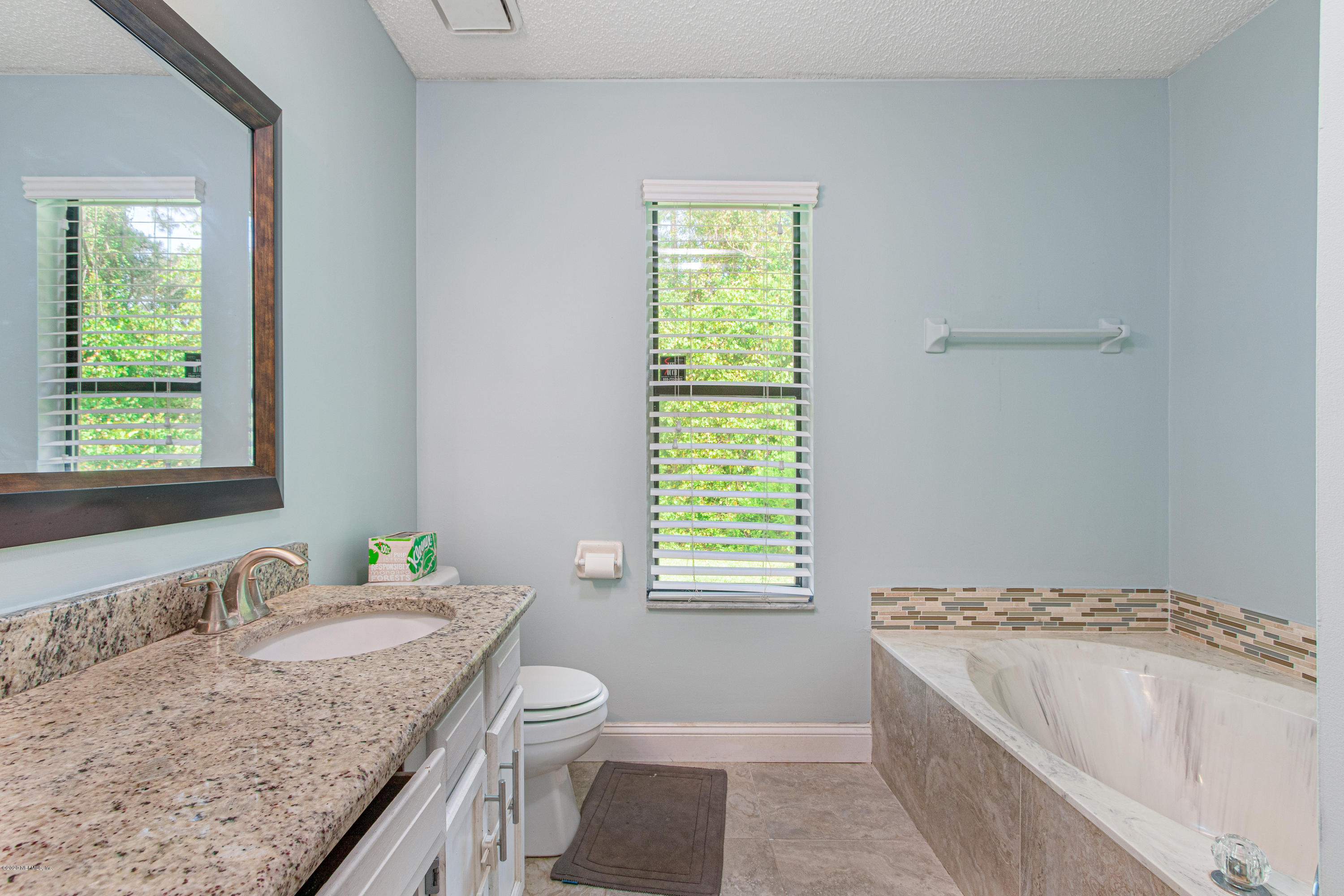 1214 Raleigh Ridge Drive Jacksonville, FL 32225 - Photo 11 of 25 a bathroom with a granite countertop sink and a bathtub