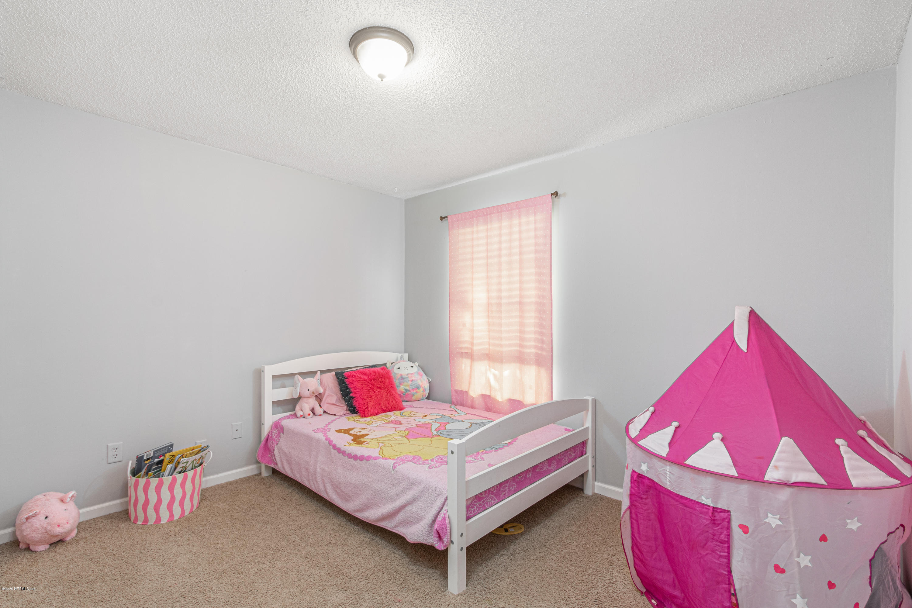 1214 Raleigh Ridge Drive Jacksonville, FL 32225 - Photo 15 of 25 a bedroom with a bed and a window