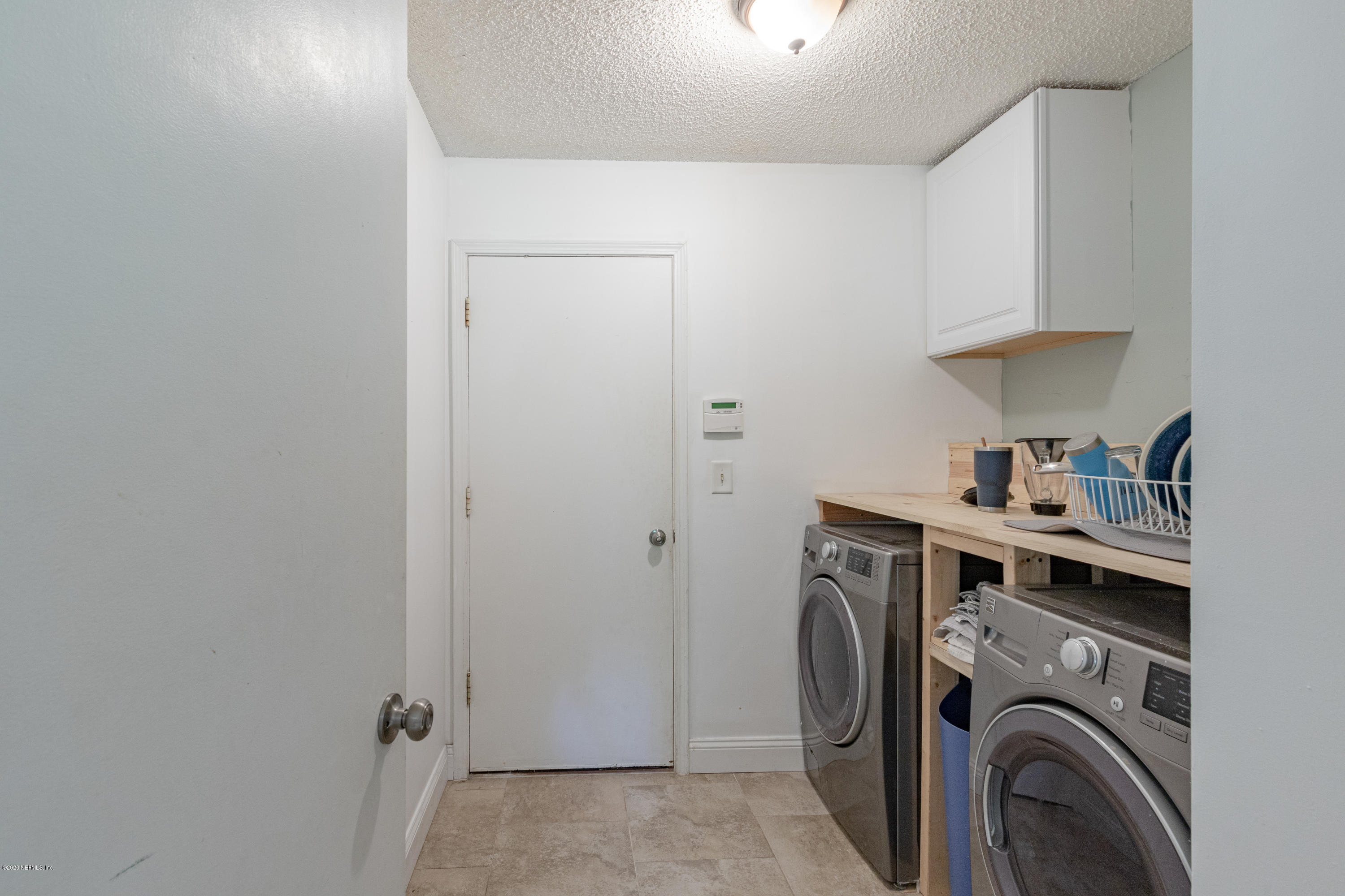 1214 Raleigh Ridge Drive Jacksonville, FL 32225 - Photo 21 of 25 a view of a storage & utility room with washer and dryer