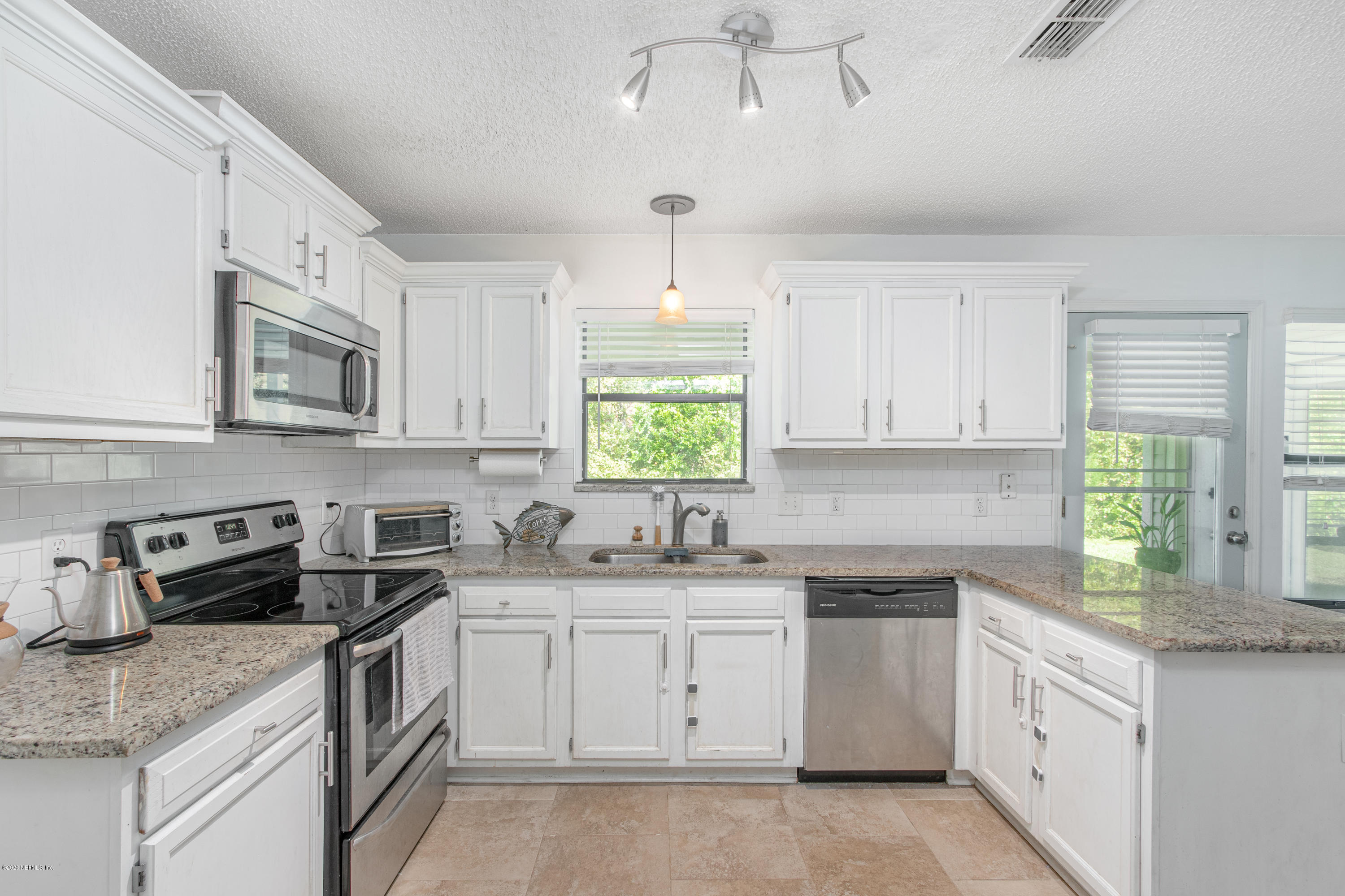 1214 Raleigh Ridge Drive Jacksonville, FL 32225 - Photo 6 of 25 a kitchen with granite countertop white cabinets white stainless steel appliances a sink and a window
