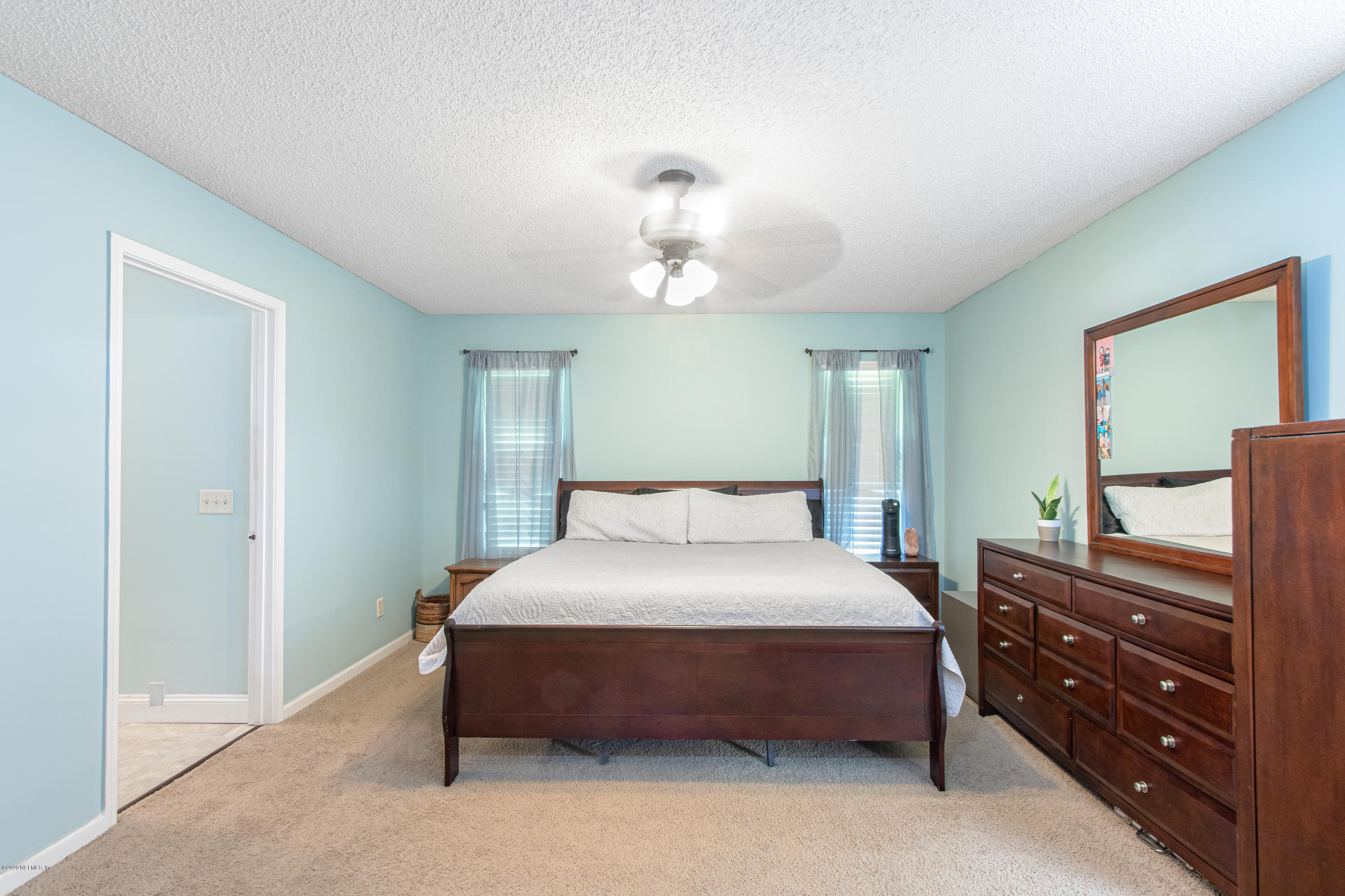 1214 Raleigh Ridge Drive Jacksonville, FL 32225 - Photo 8 of 25 a bedroom with a bed and a chandelier
