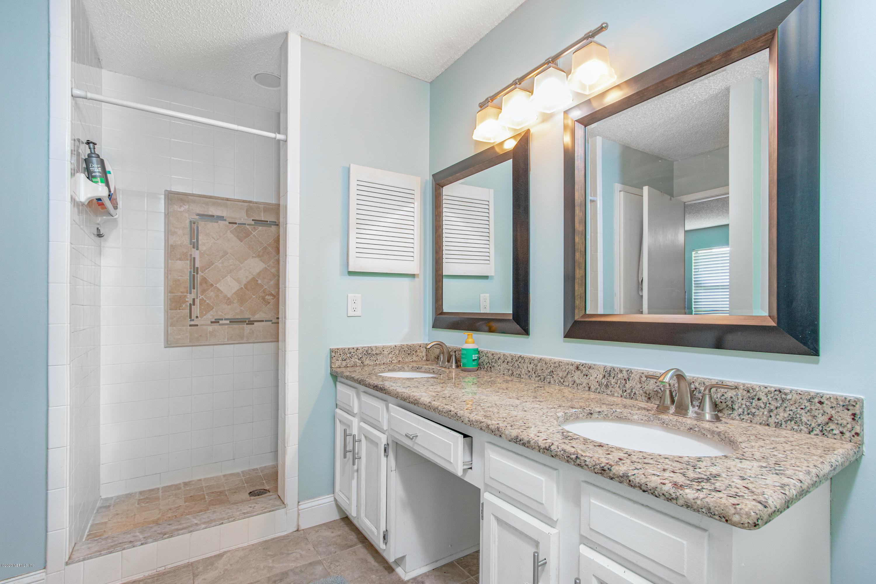 1214 Raleigh Ridge Drive Jacksonville, FL 32225 - Photo 9 of 25 a bathroom with a granite countertop sink and a mirror