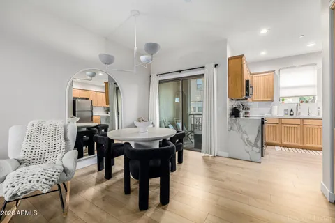 a kitchen with stainless steel appliances kitchen island granite countertop a sink and a refrigerator