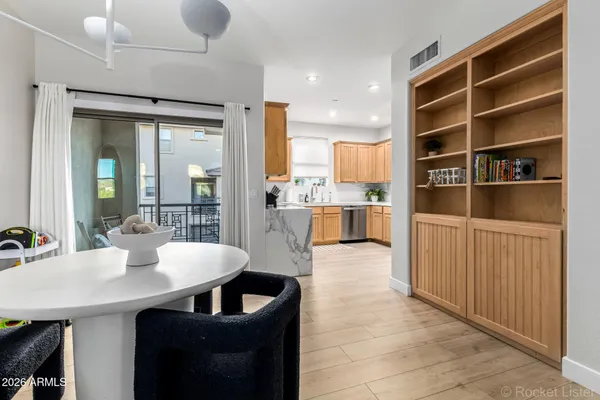 a kitchen with a table chairs refrigerator and cabinets