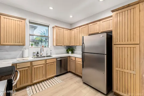 a kitchen with a refrigerator a sink and cabinets