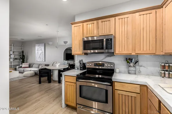 a kitchen with a stove a sink and a microwave